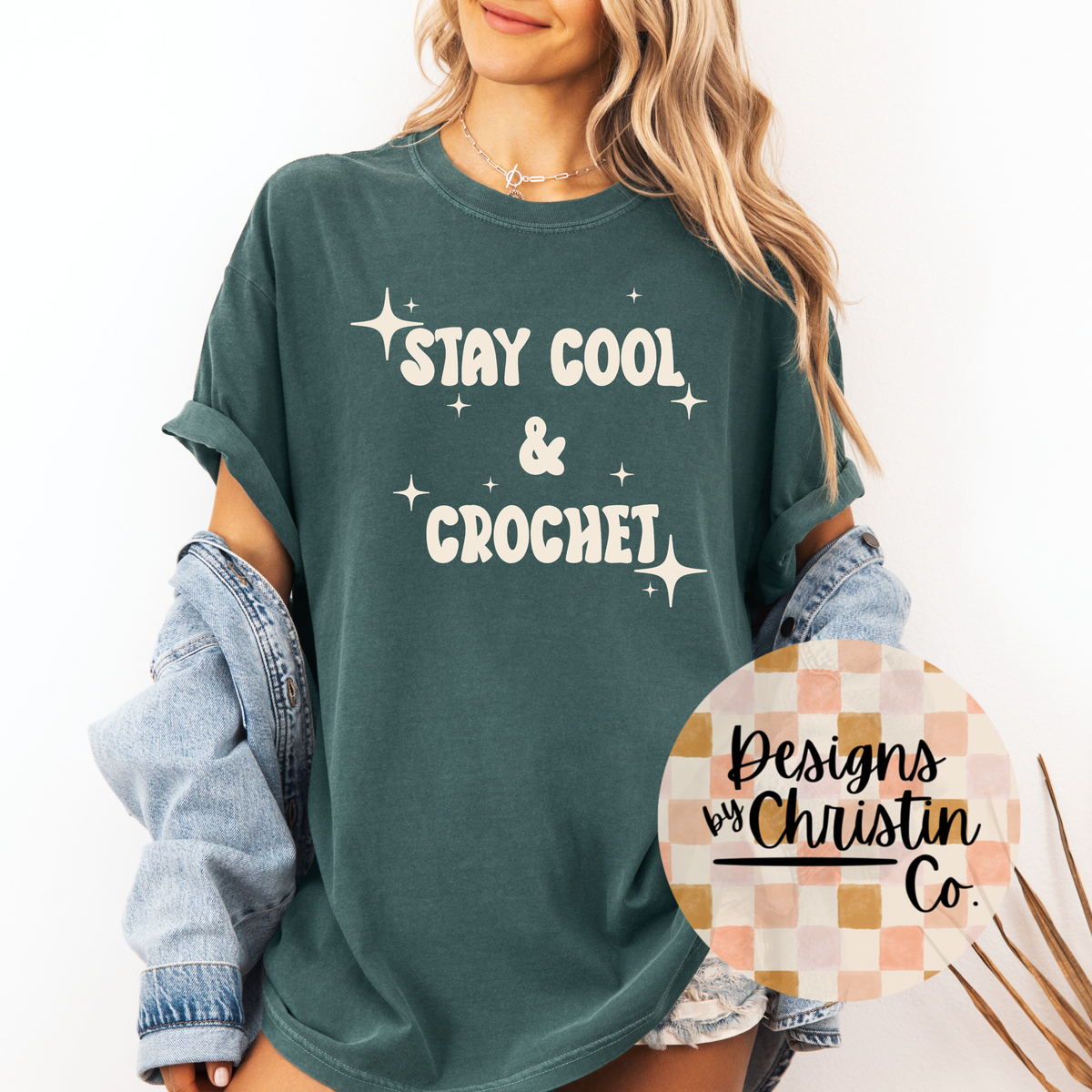 Person wearing a green t-shirt with 'Stay Cool & Crochet' text, standing against a white background.