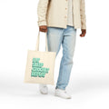 Person holding a tote bag with 'Eat Sleep Crochet Repeat' text on a white background