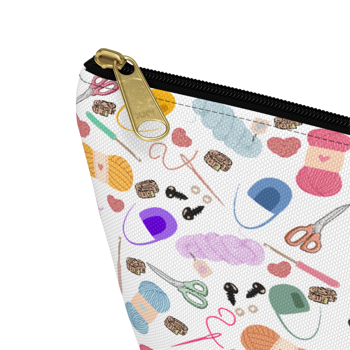 Pouch with sewing-themed design and gold zipper on a white background