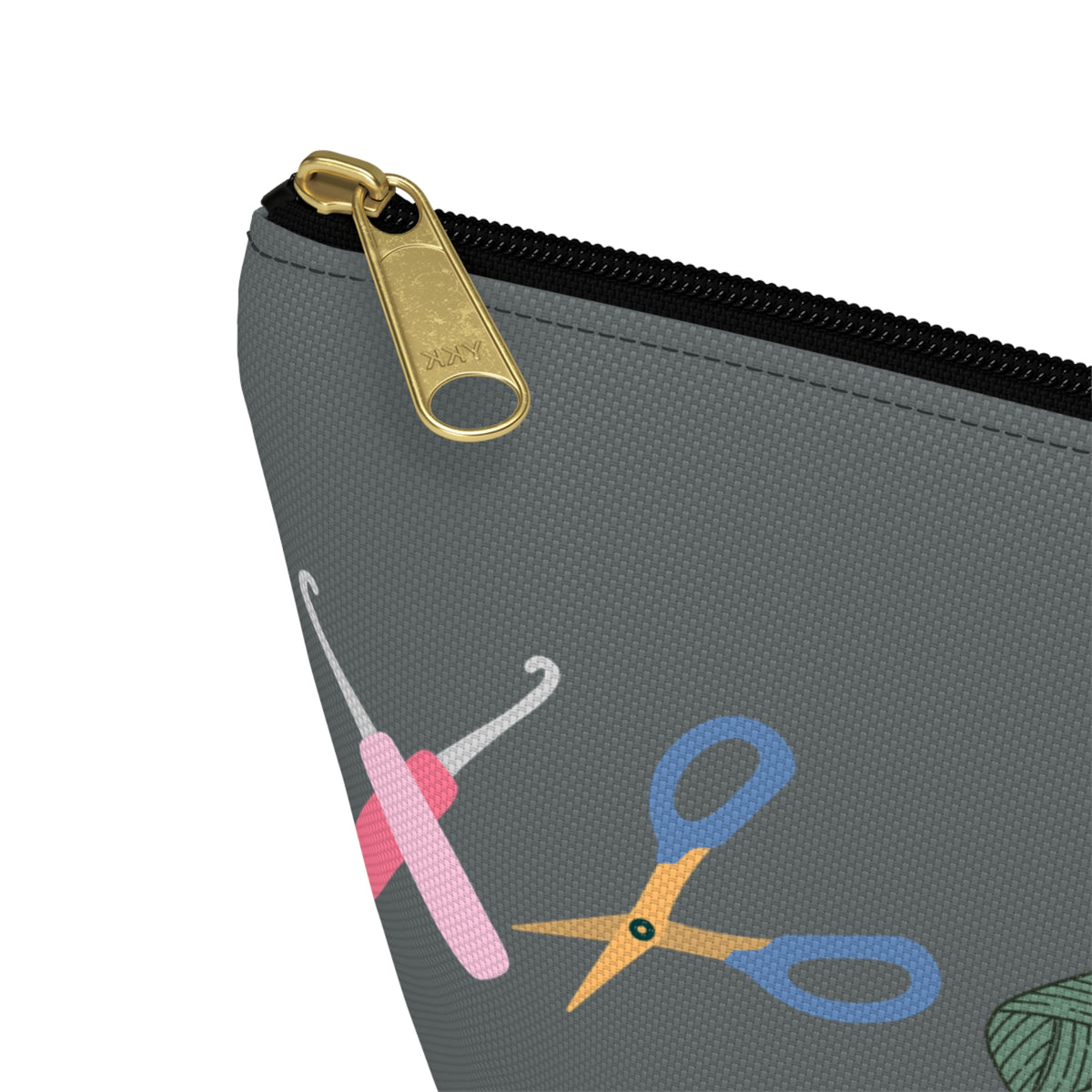 Gray pouch with colorful scissors and crochet hook design on a white background