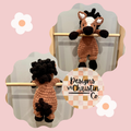 A crochet plush horse lovey in brown, white, and black with a stuffed head and hooves and an unstuffed body.