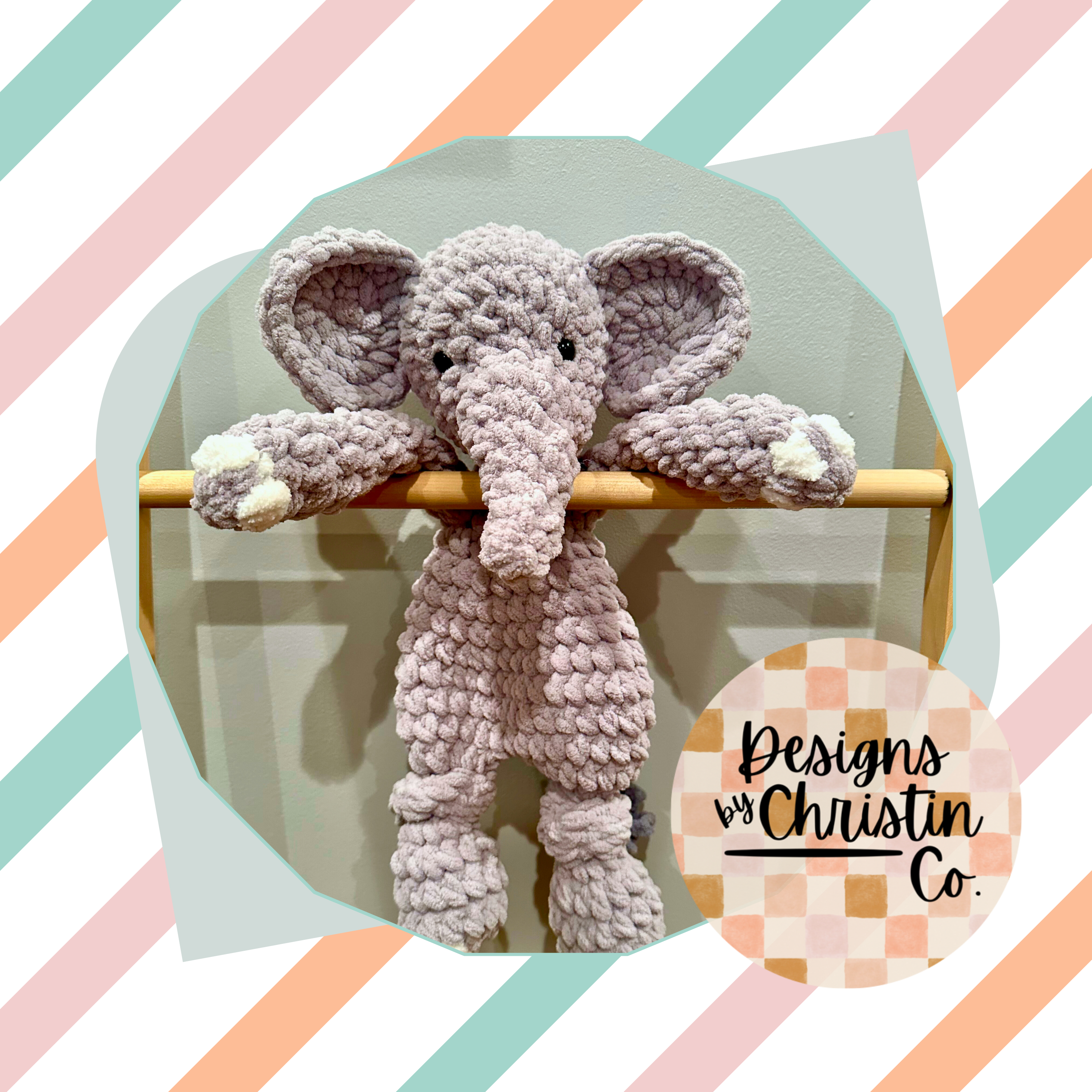 A crochet gray and white elephant plush lovey with a stuffed head and unstuffed body.