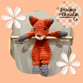 A crochet orange and gray fox lovey baby plush toy with a stuffed head and an unstuffed body.