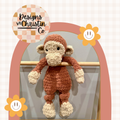 A crochet plush monkey lovey with a stuffed head and an unstuffed body.