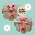 A crochet plush pig toy with a stuffed head and hooves, and an unstuffed body.