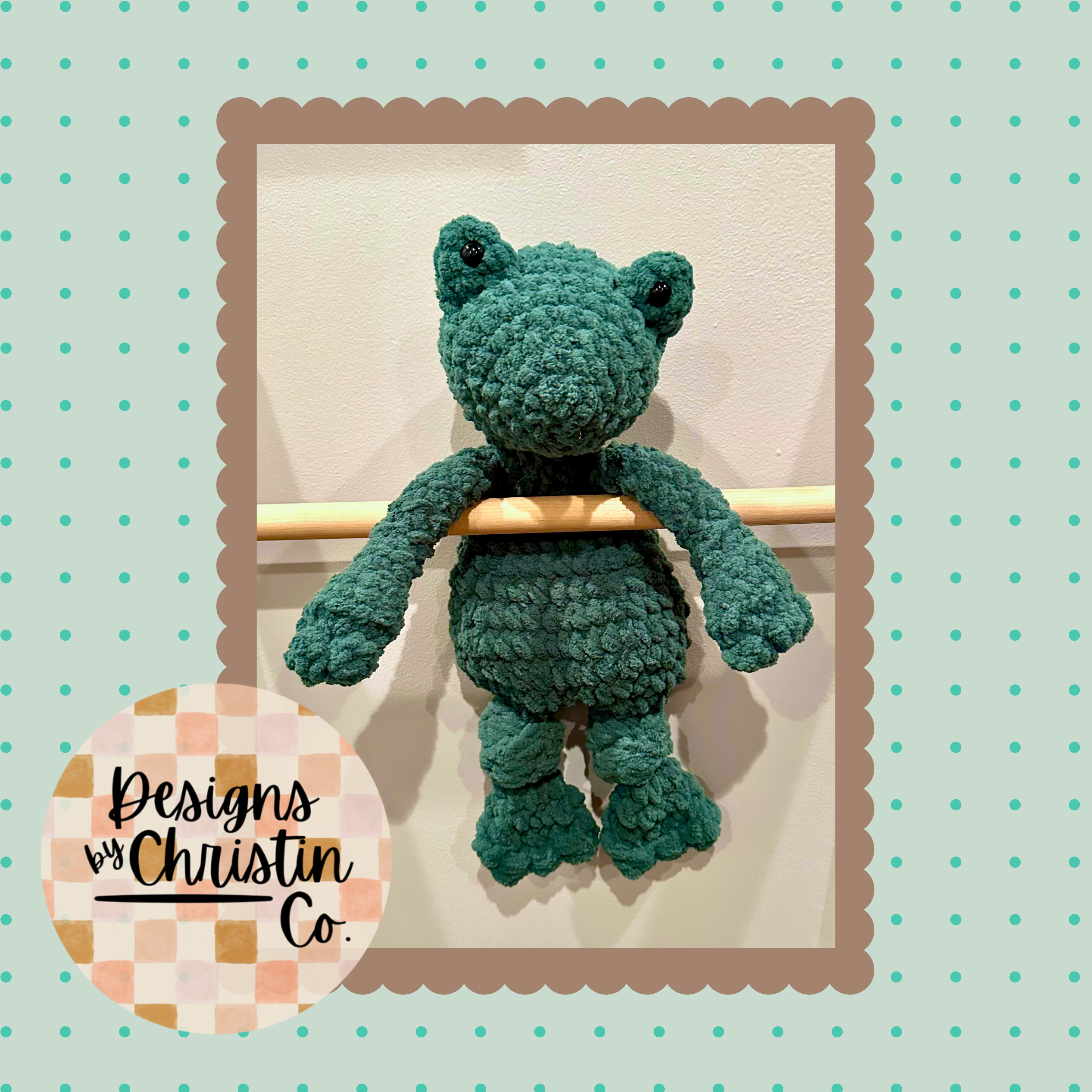 a crochet green frog plush lovey with a stuffed head and an unstuffed body.